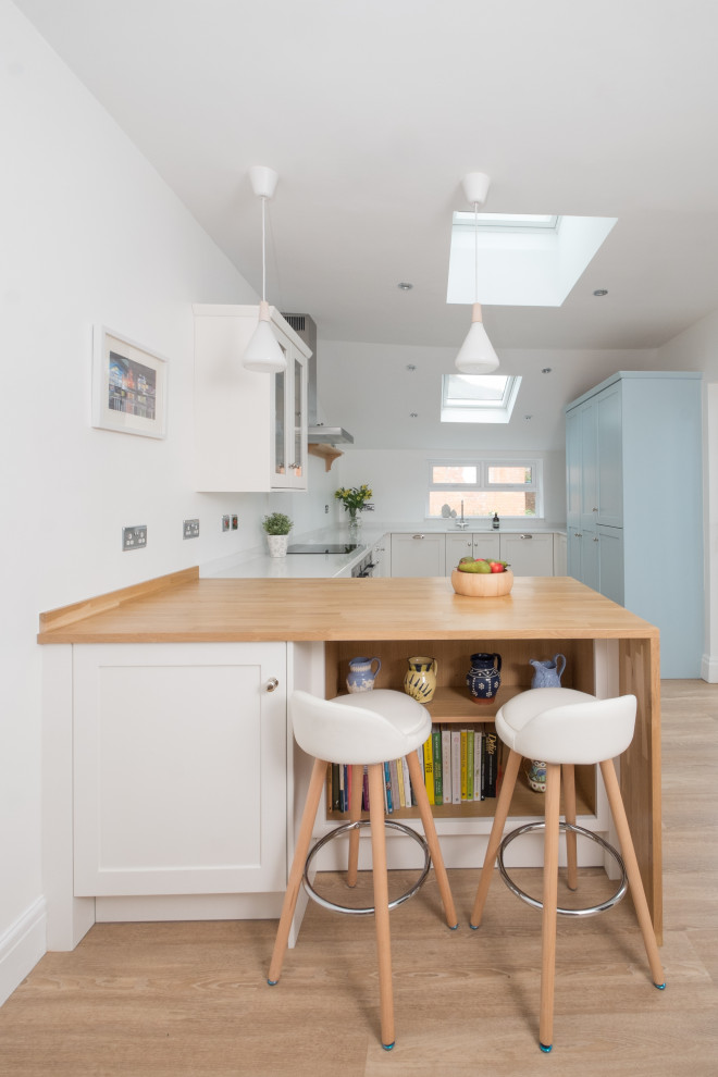 This is an example of a mid-sized beach style kitchen in Cardiff.