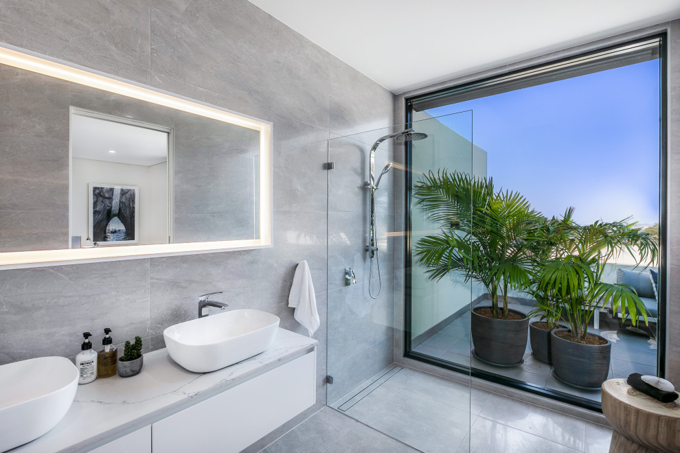 Contemporary master bathroom in Sydney with flat-panel cabinets, white cabinets, a curbless shower, gray tile, grey walls, a vessel sink, grey floor, an open shower, white benchtops, a double vanity and a floating vanity.