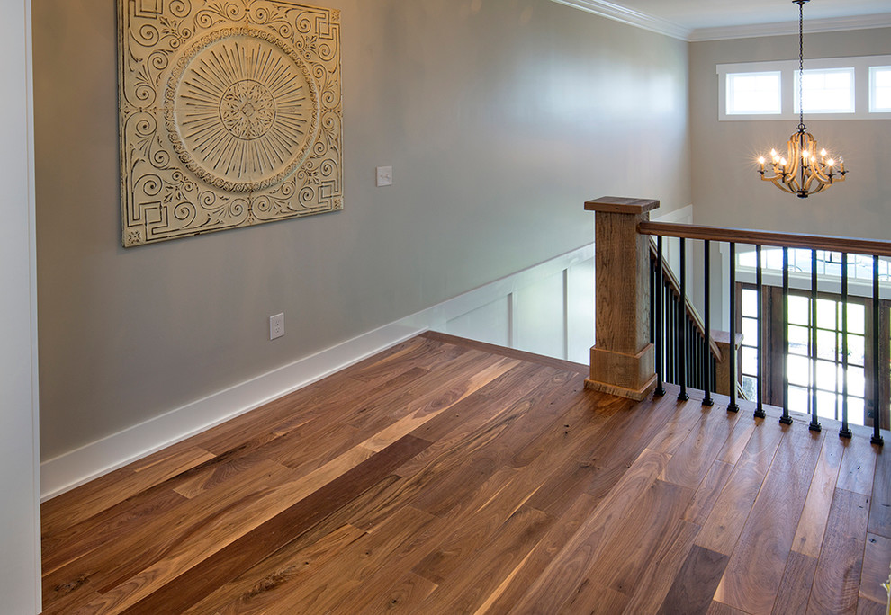 This is an example of a large country hallway in Columbus with beige walls and medium hardwood floors.