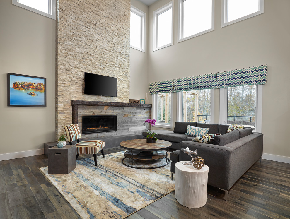 Mid-sized transitional open concept living room in Edmonton with beige walls, medium hardwood floors, a ribbon fireplace, a stone fireplace surround, a built-in media wall and brown floor.