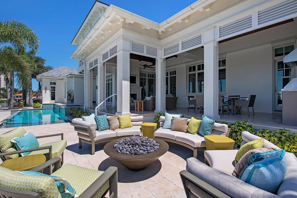 Inspiration for a mid-sized transitional backyard tile patio remodel in Miami with a fire pit and no cover