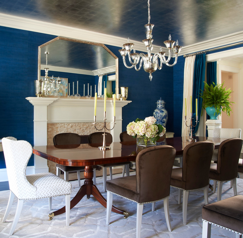 Design ideas for a traditional separate dining room in New York with blue walls and a stone fireplace surround.
