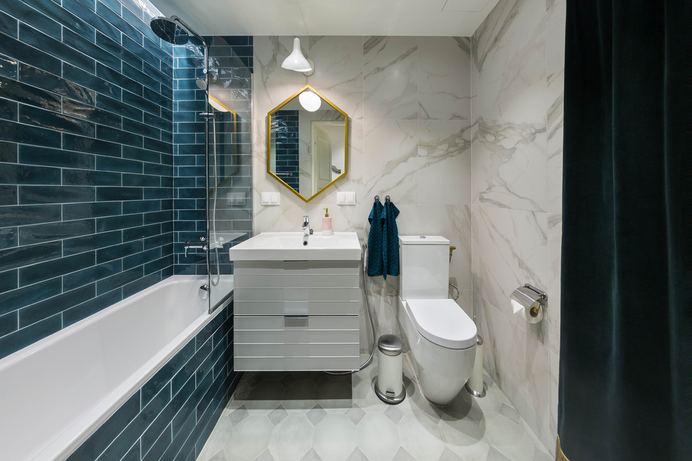 Mid-sized master bathroom in Saint Petersburg with flat-panel cabinets, white cabinets, an undermount tub, a shower/bathtub combo, a one-piece toilet, white tile, subway tile, white walls, ceramic floors, a drop-in sink, grey floor and a shower curtain.