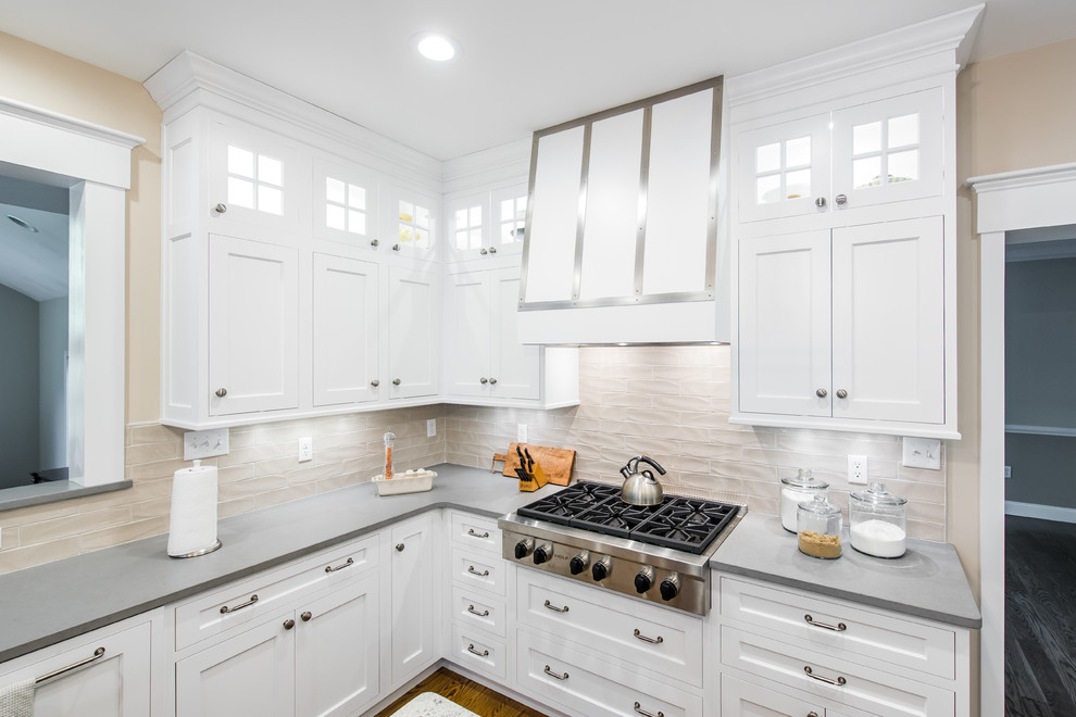 Inspiration for a mid-sized traditional u-shaped separate kitchen in Boston with an undermount sink, shaker cabinets, stainless steel appliances, dark hardwood floors, with island, white cabinets, granite benchtops, beige splashback and porcelain splashback.