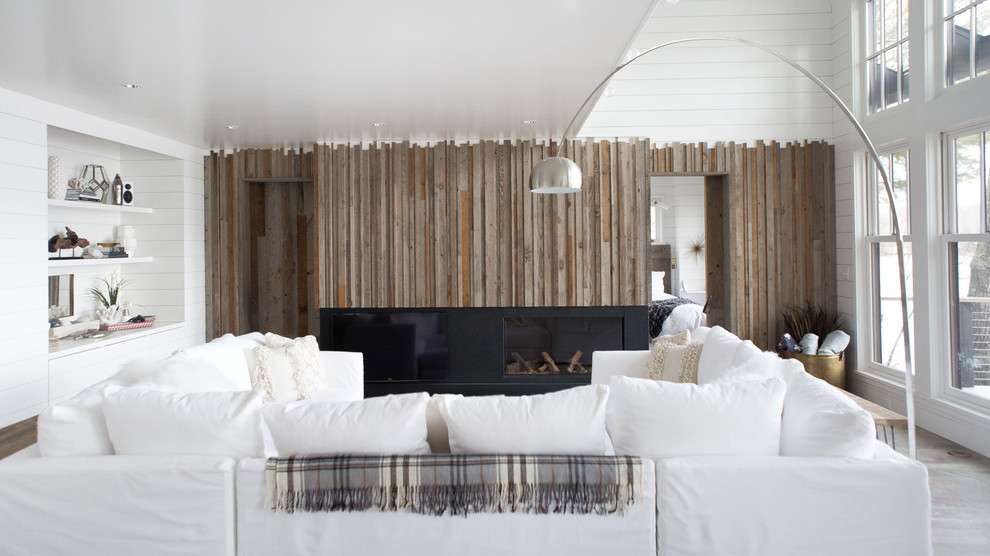 Mid-sized transitional enclosed light wood floor living room photo in Minneapolis with white walls, a ribbon fireplace, a wood fireplace surround and a media wall