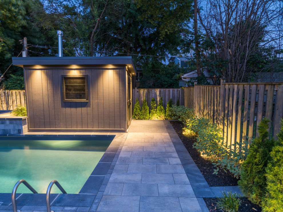Pool fountain - mid-sized transitional backyard concrete paver and l-shaped lap pool fountain idea in Toronto