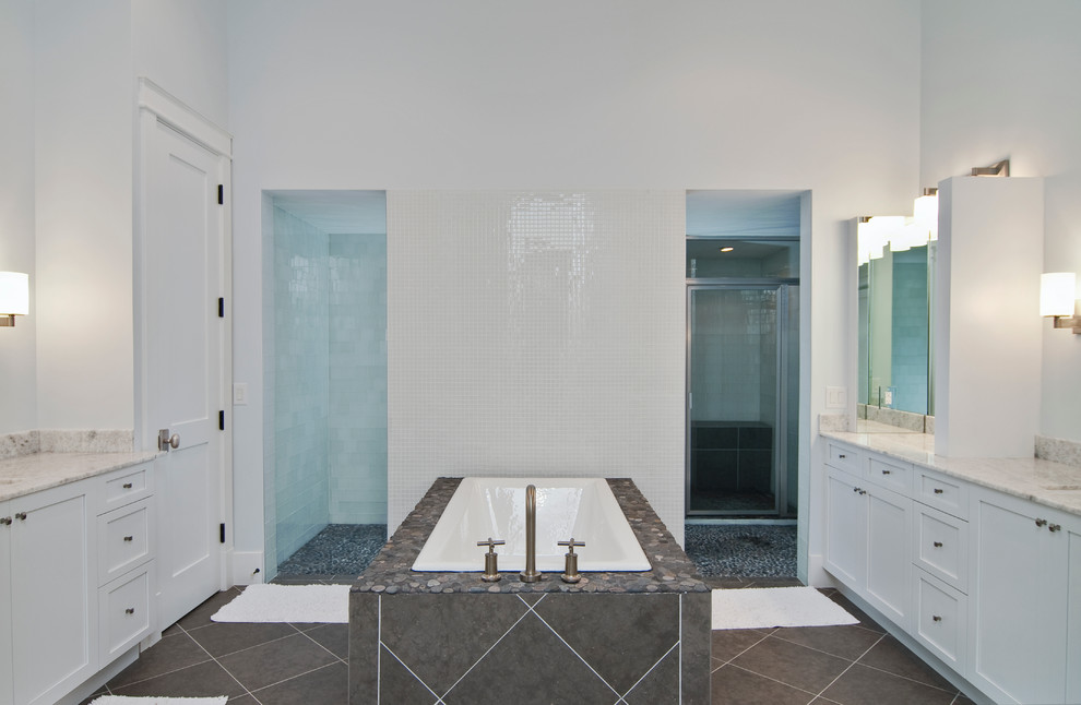 Large transitional master bathroom in Miami with an undermount sink, shaker cabinets, white cabinets, granite benchtops, a freestanding tub, an open shower, gray tile, porcelain tile, white walls and ceramic floors.