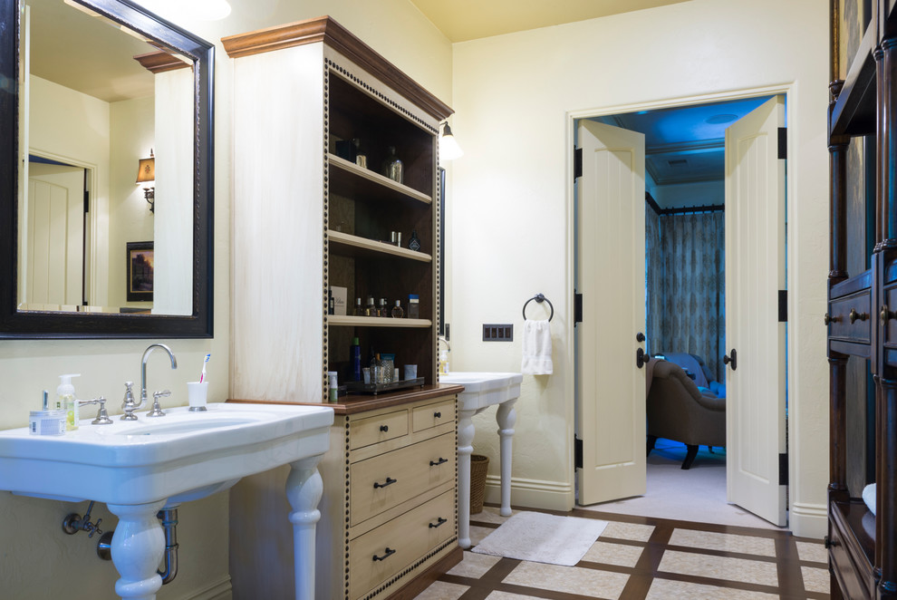 Example of a large classic master ceramic tile and beige floor freestanding bathtub design in Sacramento with flat-panel cabinets, beige cabinets, beige walls and a console sink
