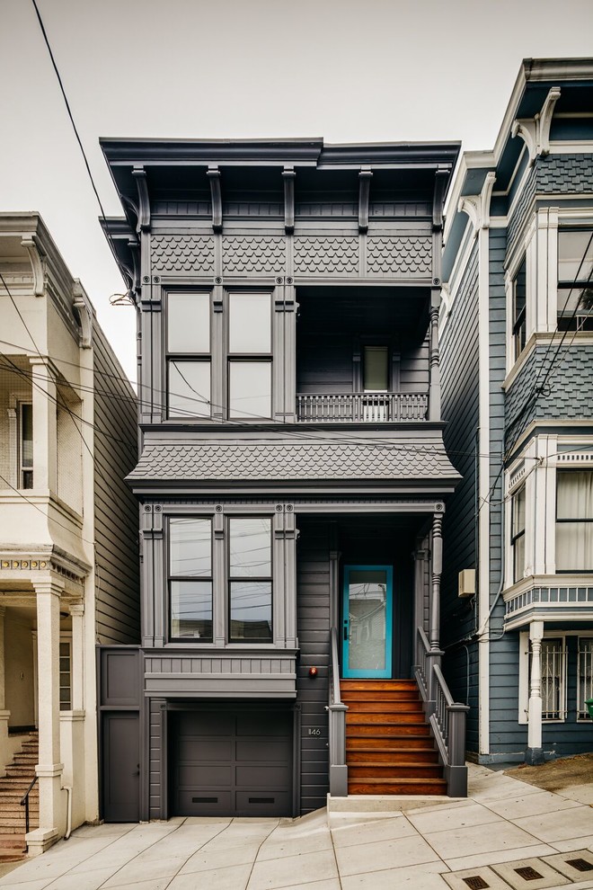 Traditional three-storey grey house exterior in San Francisco with a flat roof.