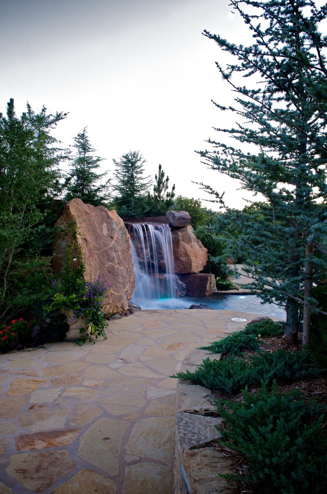 Inspiration for an expansive country backyard custom-shaped natural pool in Oklahoma City with a hot tub.