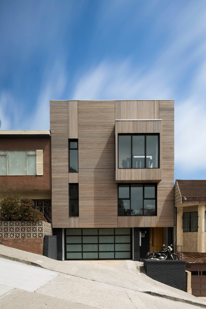 Inspiration for a modern three-storey house exterior in San Francisco with wood siding.