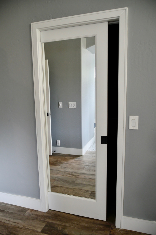 Photo of a transitional storage and wardrobe in Phoenix with porcelain floors and brown floor.