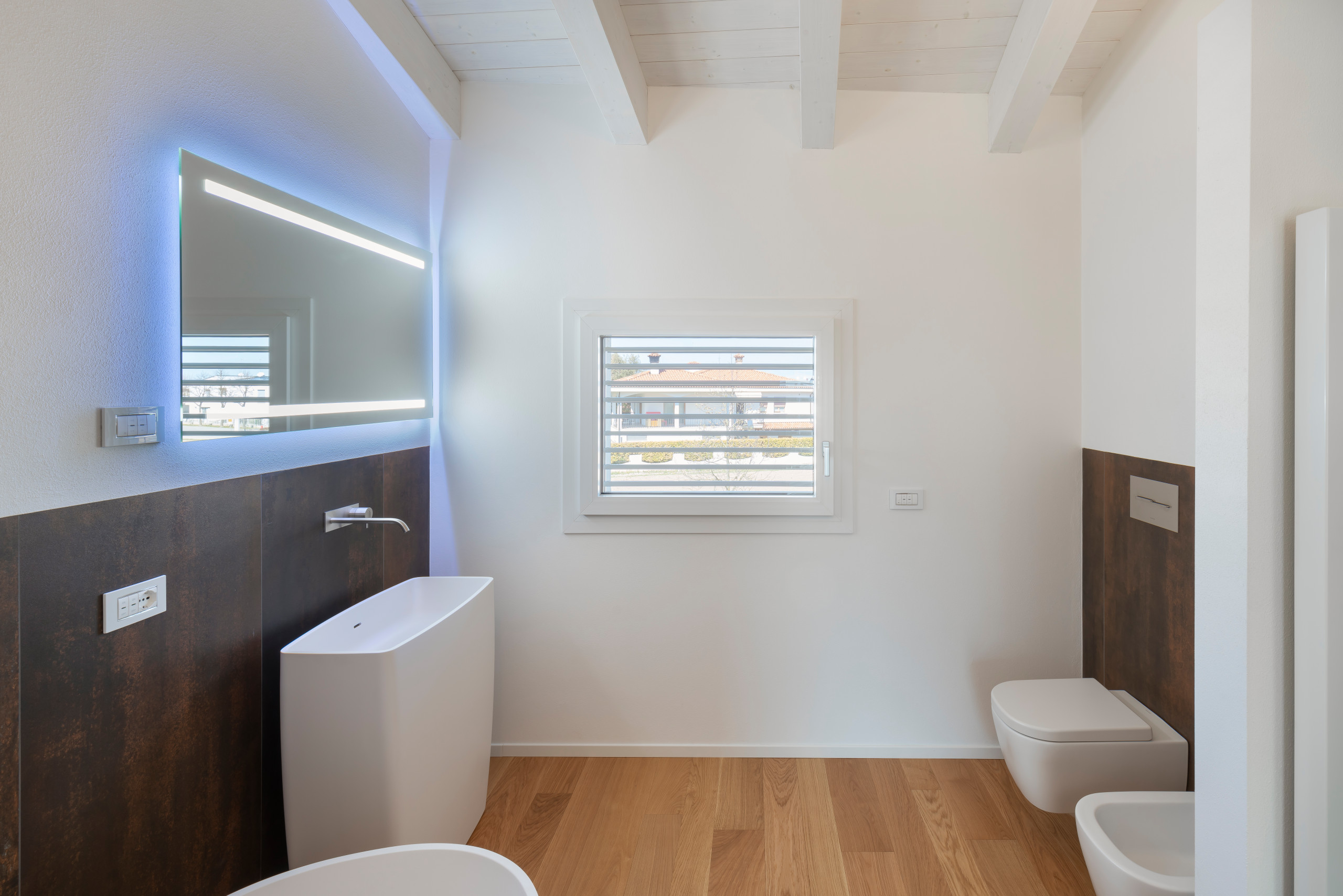 Bathroom - large contemporary porcelain tile medium tone wood floor and single-sink bathroom idea in Other with a wall-mount toilet and a pedestal sink