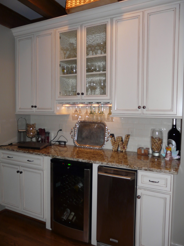 Example of a transitional eat-in kitchen design in Birmingham with a farmhouse sink, flat-panel cabinets, granite countertops, porcelain backsplash and stainless steel appliances