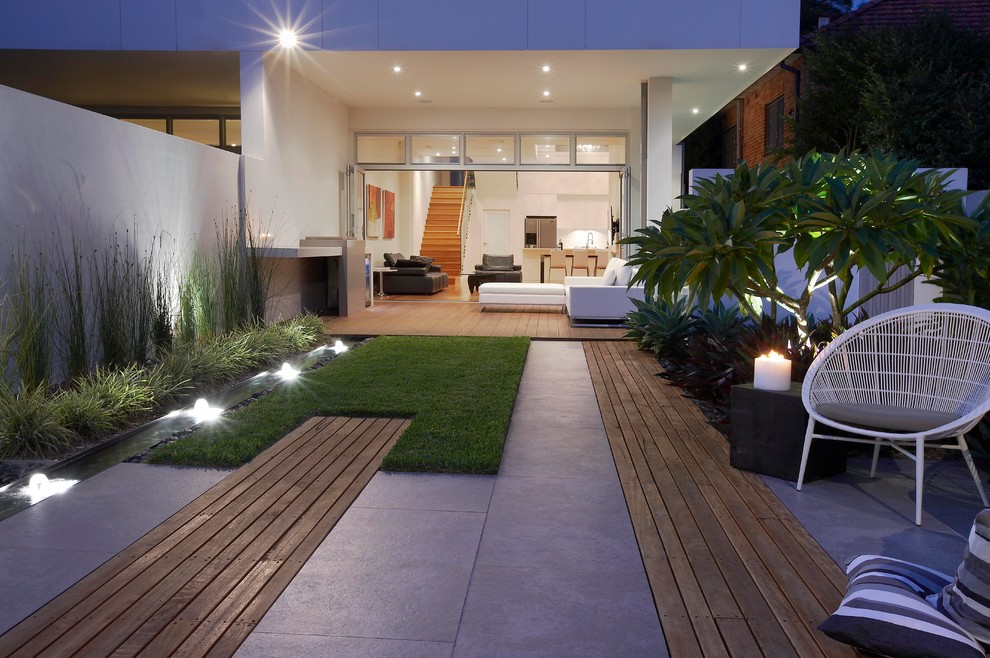 Australian native contemporary backyard garden in Sydney with a water feature.