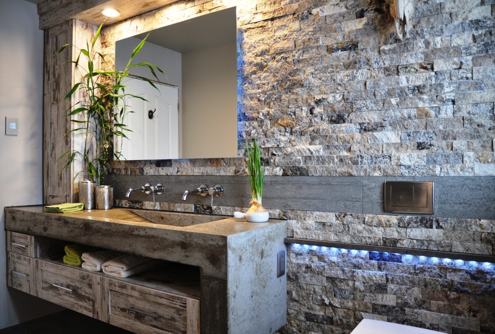 Bathroom - large rustic master bathroom idea in Ottawa with an integrated sink, shaker cabinets, concrete countertops, a wall-mount toilet and beige walls
