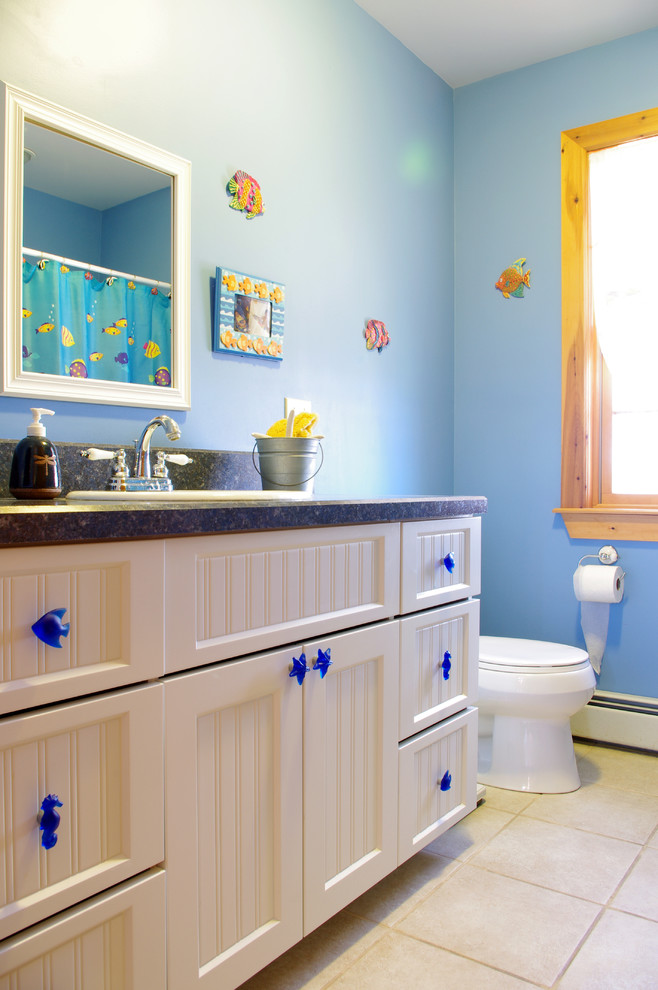 Design ideas for a small beach style kids bathroom in New York with shaker cabinets, white cabinets, laminate benchtops, white tile, blue walls and ceramic floors.