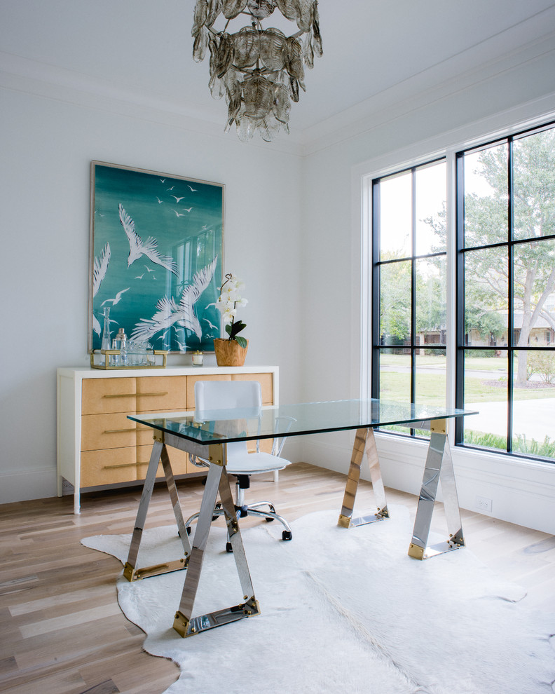 Inspiration for a contemporary home office in Dallas with white walls, light hardwood floors and a freestanding desk.