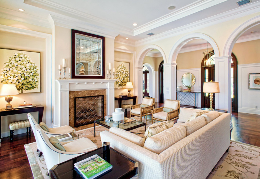 This is an example of a traditional formal open concept living room in Other with yellow walls, dark hardwood floors, a standard fireplace and a stone fireplace surround.