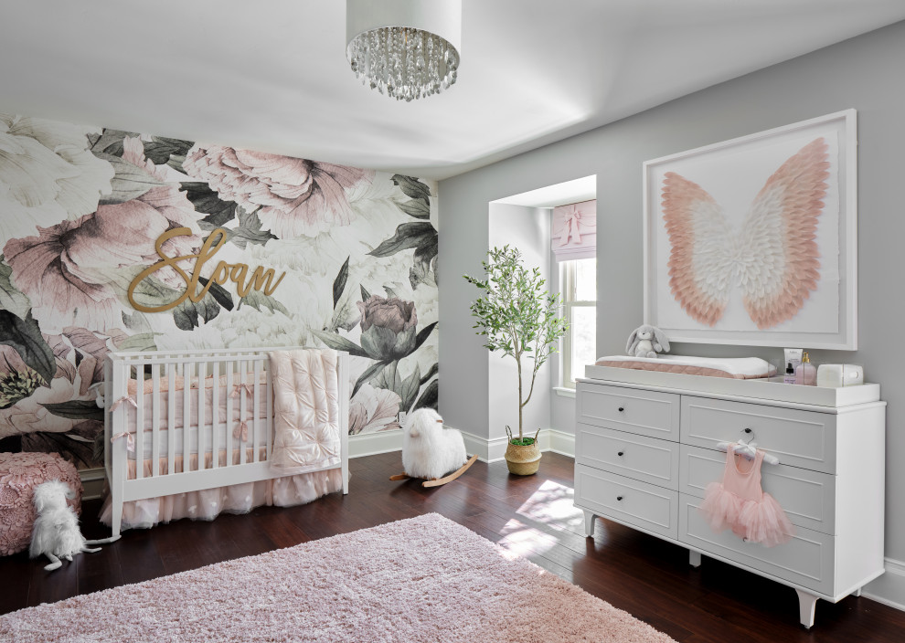 Imagen de habitación de bebé niña tradicional grande con paredes grises, suelo de madera oscura, suelo marrón y papel pintado