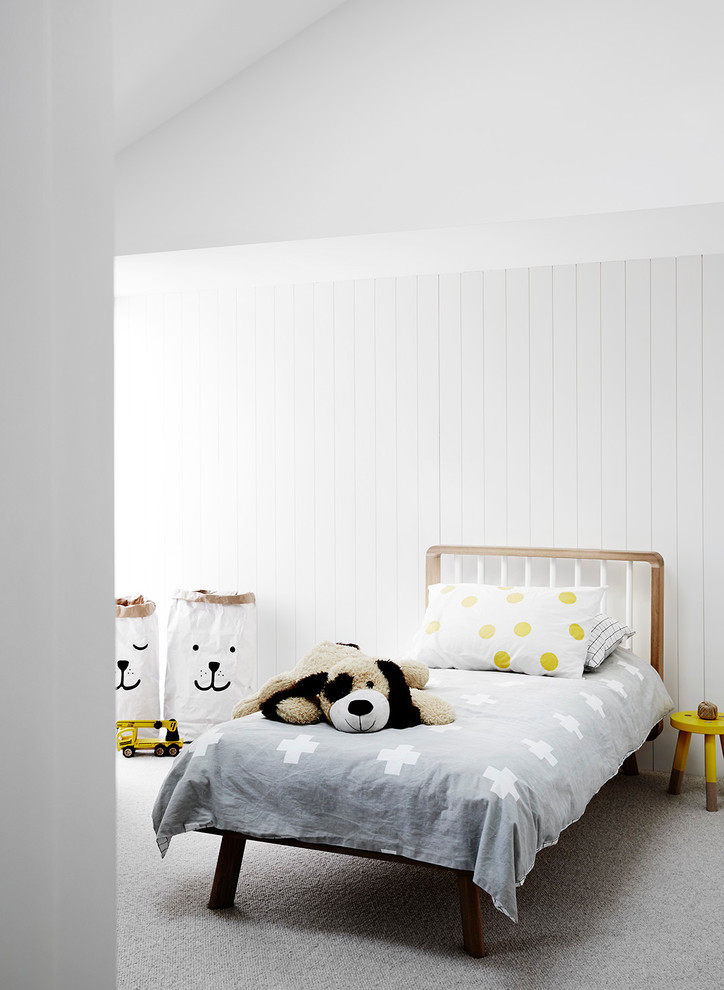 This is an example of a scandinavian gender-neutral kids' room in Melbourne with white walls, carpet and grey floor.