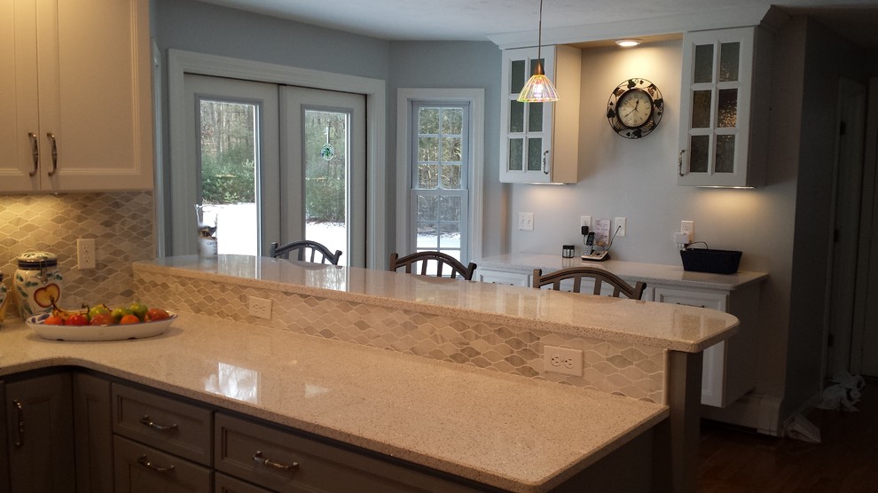 Kitchen - transitional u-shaped kitchen idea in Boston with gray cabinets, quartz countertops, gray backsplash, mosaic tile backsplash, stainless steel appliances and a peninsula