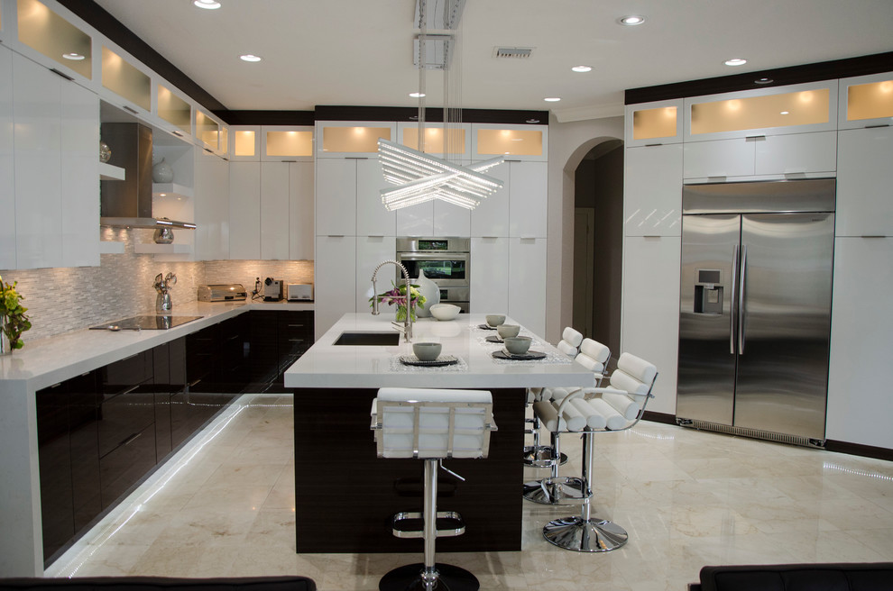 Photo of a large contemporary open plan kitchen in Miami with an undermount sink, flat-panel cabinets, white cabinets, quartz benchtops, multi-coloured splashback, mosaic tile splashback, stainless steel appliances, porcelain floors and with island.