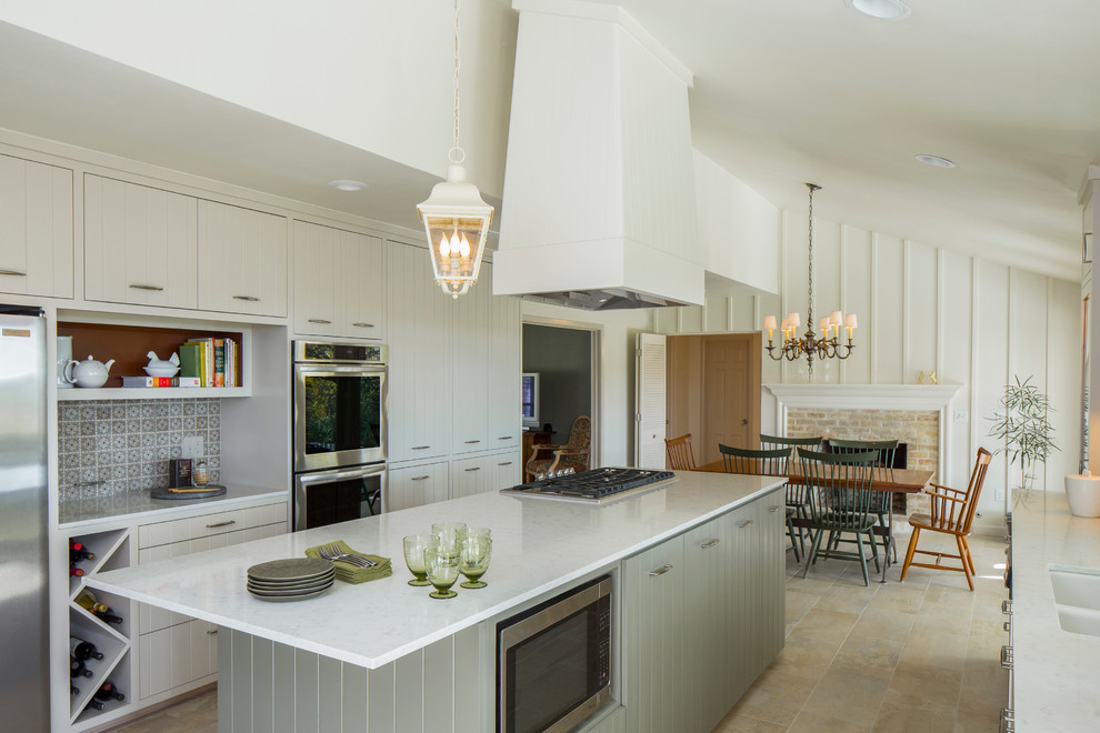 Inspiration for a mid-sized transitional galley porcelain tile eat-in kitchen remodel in Austin with a double-bowl sink, white cabinets, quartz countertops, ceramic backsplash, stainless steel appliances and an island