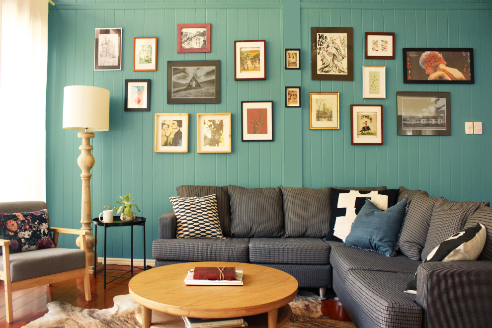 Photo of a mid-sized eclectic open concept living room with blue walls, medium hardwood floors and brown floor.