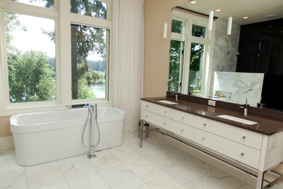 Inspiration for a large contemporary master bathroom in Portland with a freestanding tub, flat-panel cabinets, white cabinets, an open shower, gray tile, marble, beige walls, marble floors, an undermount sink, engineered quartz benchtops, white floor and an open shower.