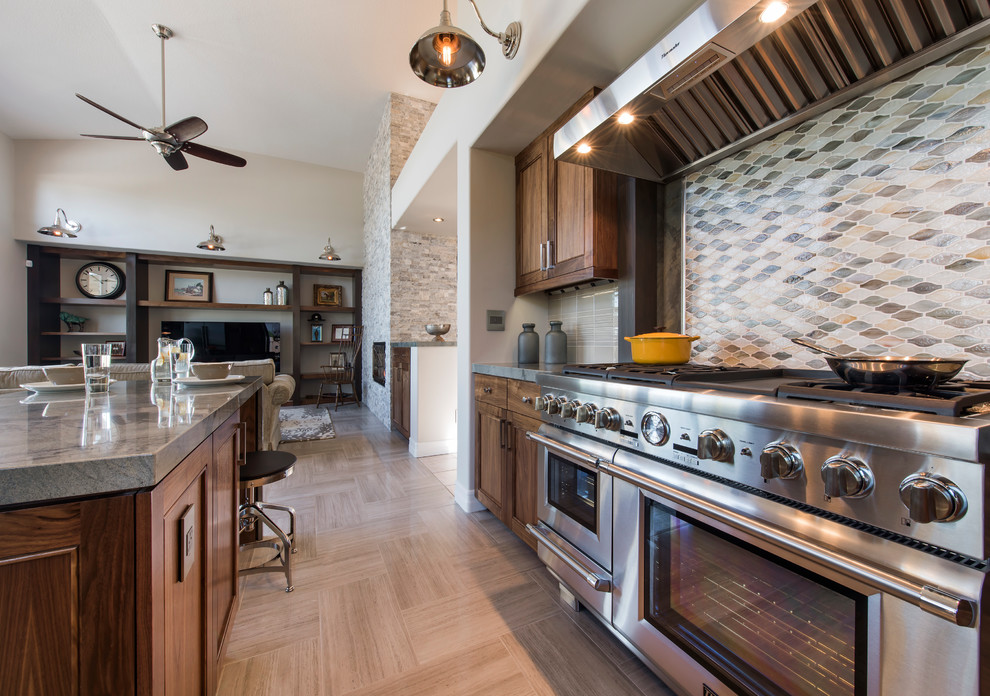 Example of a large transitional l-shaped ceramic tile and gray floor open concept kitchen design with an undermount sink, recessed-panel cabinets, dark wood cabinets, granite countertops, multicolored backsplash, mosaic tile backsplash, stainless steel appliances and an island
