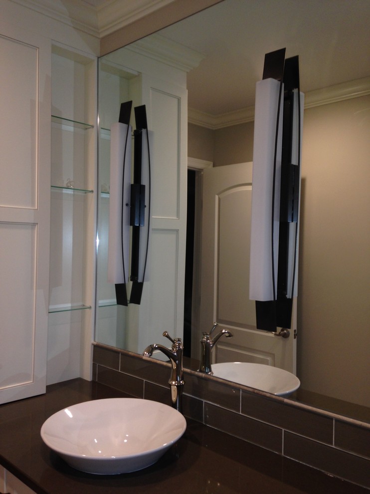 Transitional beige tile and stone tile marble floor alcove bathtub photo with a vessel sink, flat-panel cabinets, white cabinets, quartzite countertops and beige walls