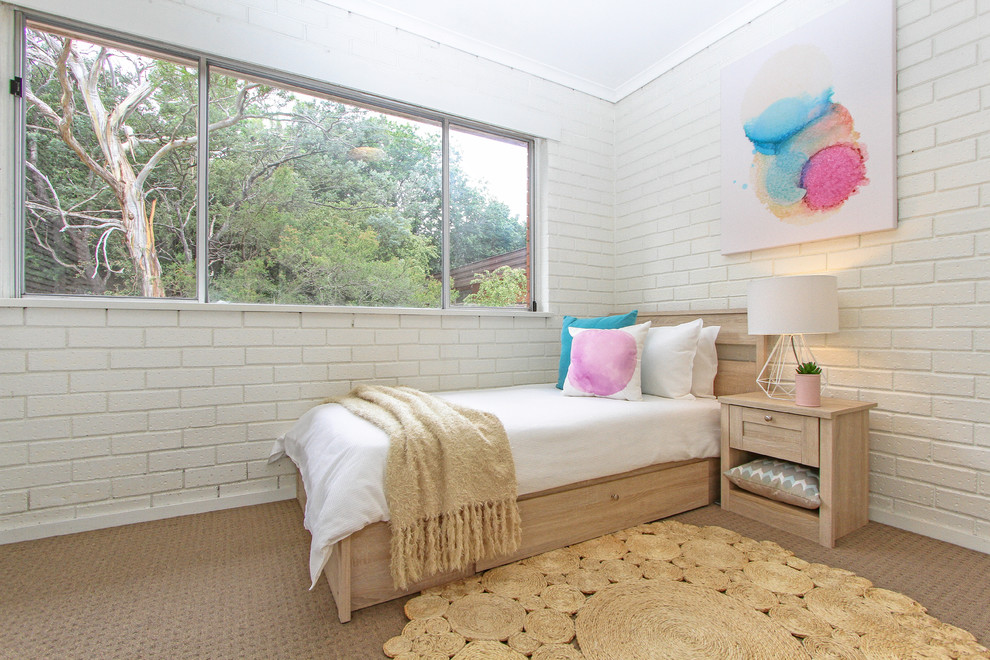 This is an example of a contemporary bedroom in Hobart with white walls and carpet.