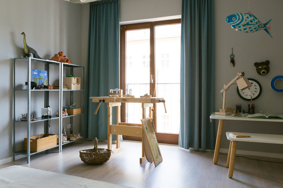 Mid-sized scandinavian kids' room in Berlin with grey walls and painted wood floors.