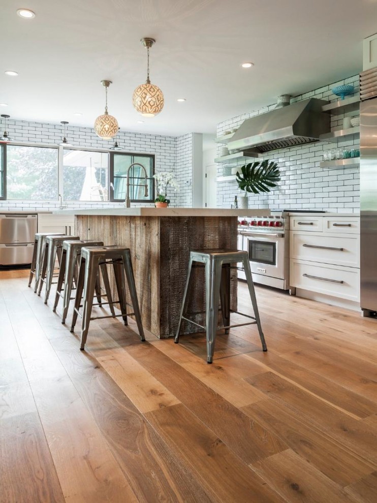 Photo of a large contemporary kitchen/dining combo in New York with light hardwood floors.
