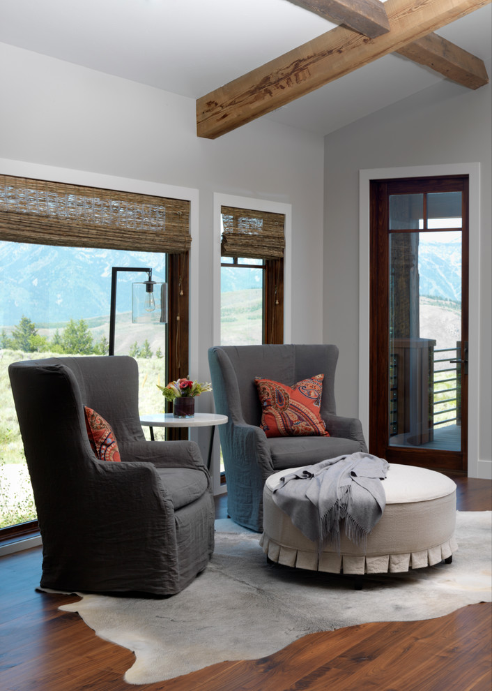 Inspiration for a large rustic master medium tone wood floor bedroom remodel with gray walls and no fireplace