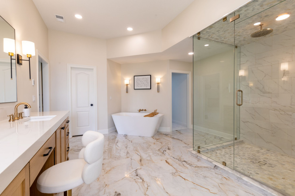 Large modern ensuite bathroom in Kansas City with shaker cabinets, light wood cabinets, a freestanding bath, marble tiles, engineered stone worktops, white worktops, double sinks and a built in vanity unit.