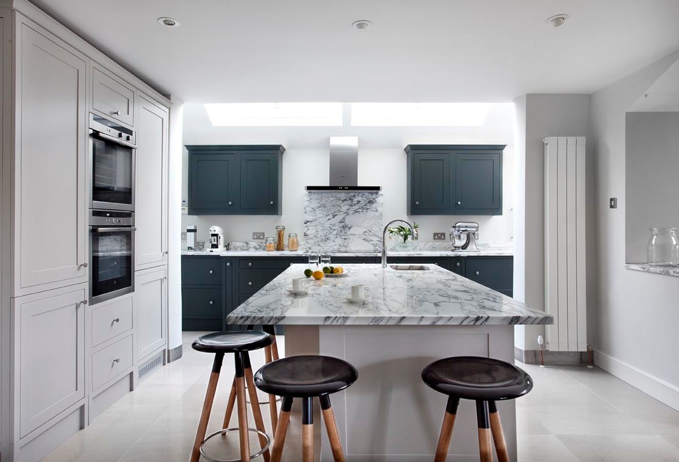 Inspiration for a mid-sized contemporary eat-in kitchen in Dublin with an integrated sink, shaker cabinets, grey cabinets, marble benchtops, grey splashback, stone slab splashback, stainless steel appliances and with island.