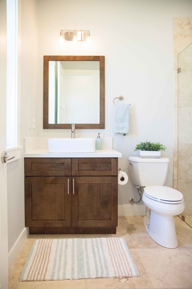 This is an example of a small contemporary 3/4 bathroom in Hawaii with shaker cabinets, brown cabinets, an alcove shower, a two-piece toilet, white walls, travertine floors, a vessel sink, engineered quartz benchtops, beige floor and an open shower.