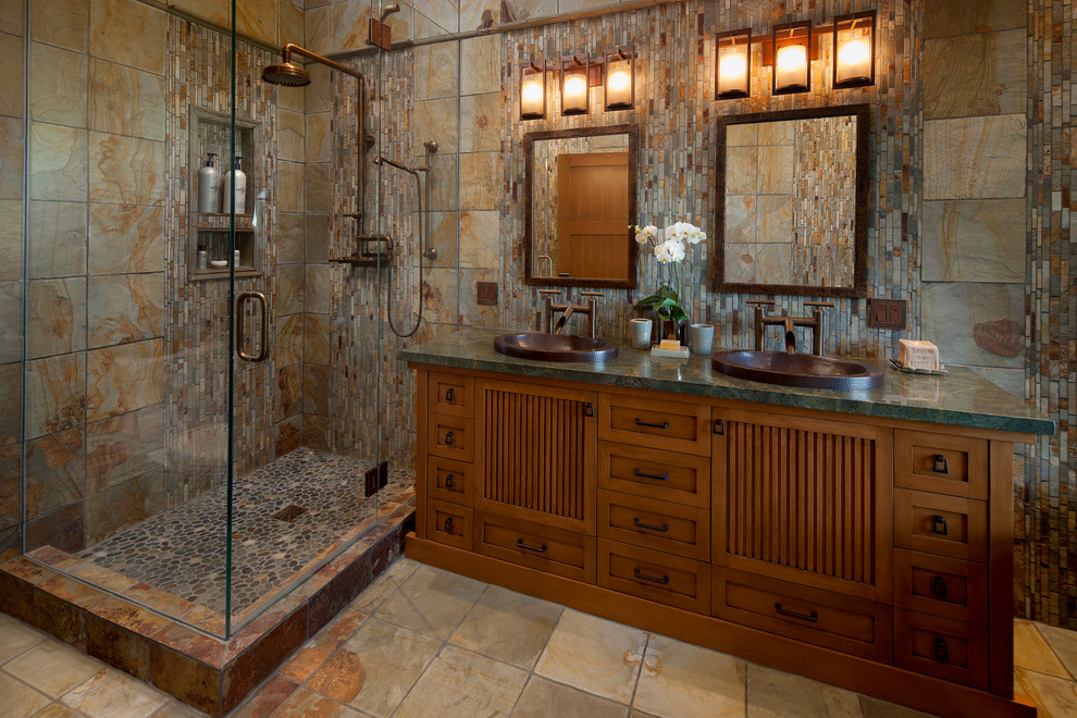 Design ideas for a mid-sized asian master bathroom in Santa Barbara with a drop-in sink, medium wood cabinets, granite benchtops, a corner shower, stone tile, multi-coloured walls, slate floors, brown tile, gray tile and shaker cabinets.