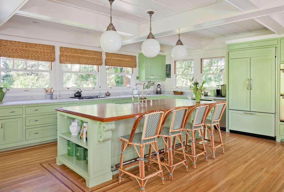 Inspiration for a traditional kitchen in San Francisco with green cabinets, wood benchtops, panelled appliances and shaker cabinets.