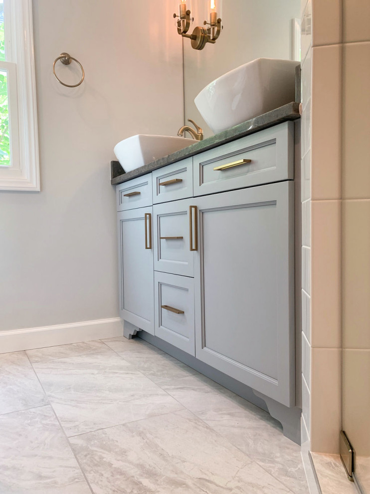 This is an example of a small transitional master bathroom in Other with shaker cabinets, grey cabinets, a double shower, a two-piece toilet, white tile, glass tile, grey walls, porcelain floors, a vessel sink, engineered quartz benchtops, grey floor, a hinged shower door, multi-coloured benchtops, a double vanity and a freestanding vanity.