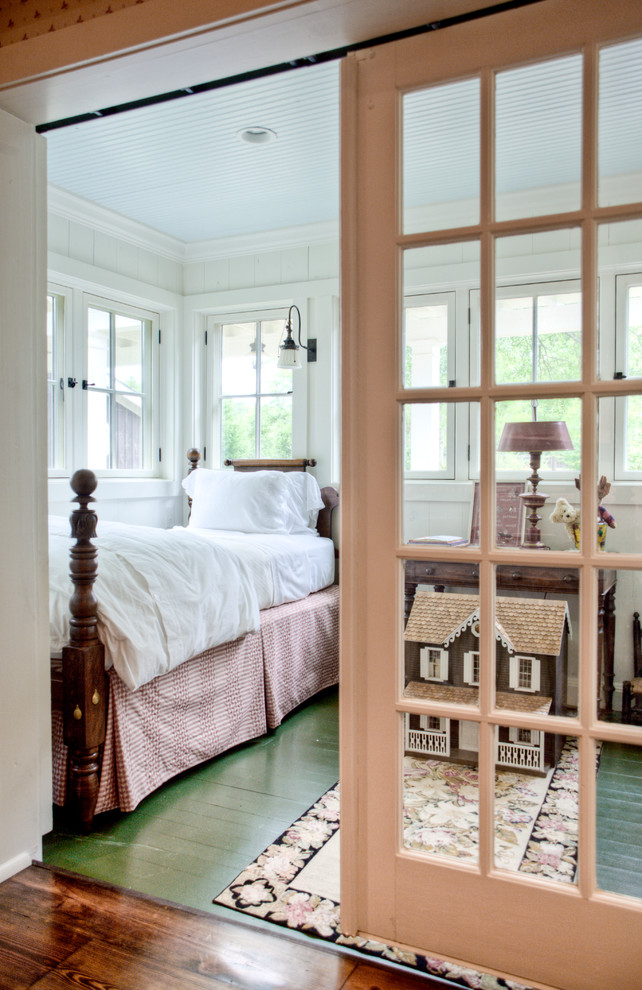 This is an example of a country kids' room in Atlanta with painted wood floors and green floor.