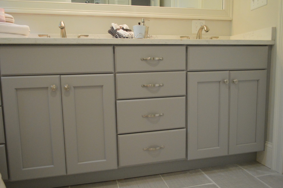 Example of a mid-sized transitional master beige tile and cement tile bathroom design in Boston with raised-panel cabinets, dark wood cabinets, a hot tub, an undermount sink, quartz countertops and beige countertops