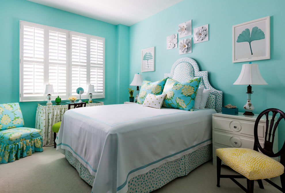 Design ideas for a mid-sized tropical guest bedroom in Miami with blue walls, carpet and beige floor.