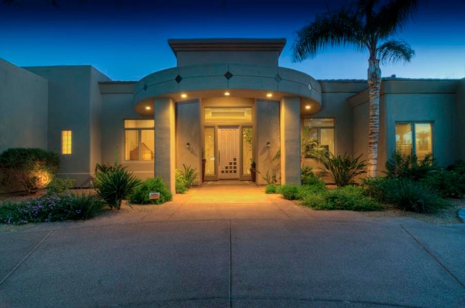 Front door - huge transitional concrete floor front door idea in Phoenix with beige walls and a glass front door