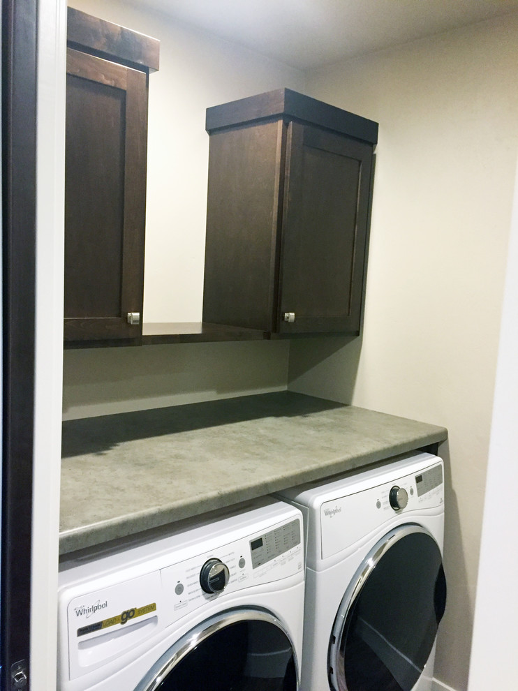Small arts and crafts single-wall dedicated laundry room in Other with shaker cabinets, dark wood cabinets, white walls and a side-by-side washer and dryer.