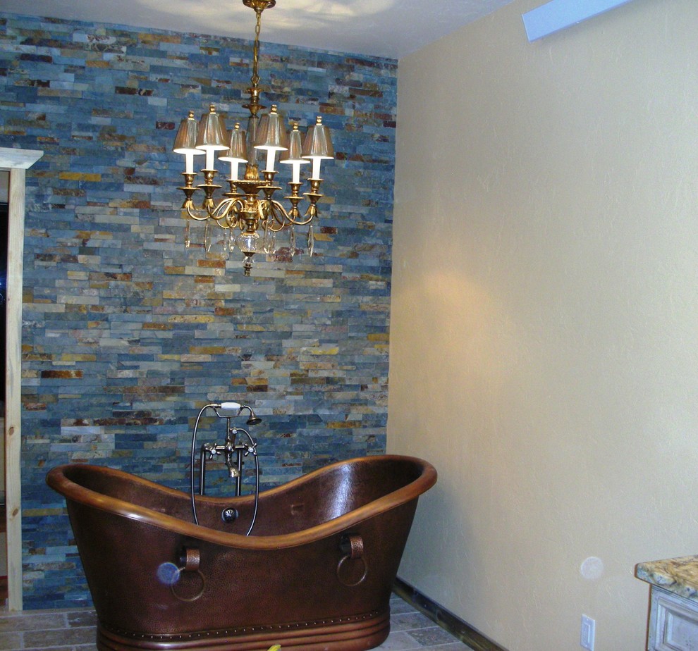 Photo of a large master bathroom in Denver with an undermount sink, granite benchtops, a freestanding tub, a double shower, beige walls, terra-cotta floors, blue tile and stone tile.