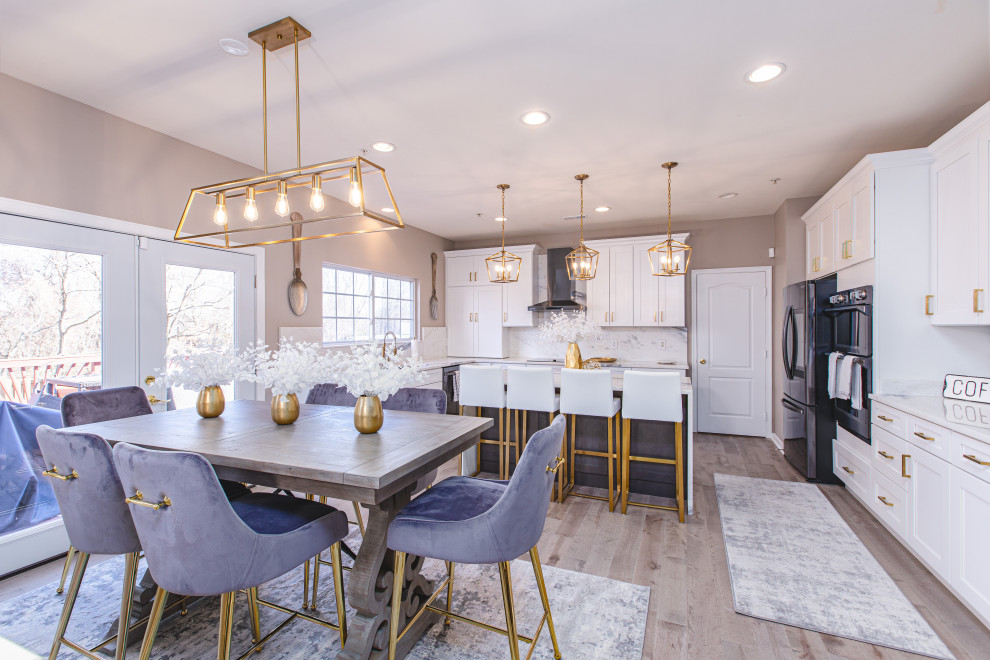 Inspiration for a large beach style single-wall eat-in kitchen in DC Metro with a double-bowl sink, shaker cabinets, white cabinets, granite benchtops, white splashback, slate splashback, black appliances, bamboo floors, with island, grey floor and white benchtop.
