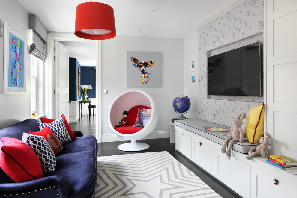 Mid-sized transitional gender-neutral kids' playroom in London with grey walls and dark hardwood floors for kids 4-10 years old.